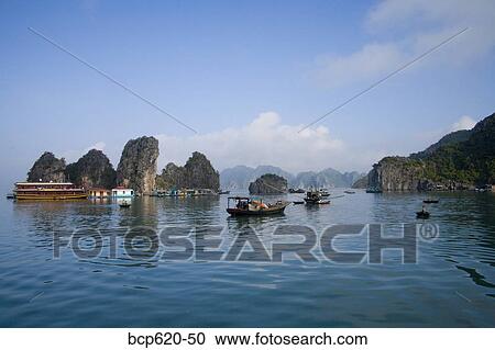 Floating Vietnamese fishing village with rocky coastline View Large Photo Image Stock Image - Floating Vietnamese fishing village with rocky coastline. Fotosearch