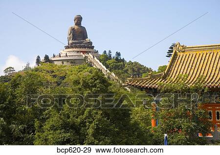 Giant Buddha atop tree covered hill in Hong Kong View Large Photo Image Stock Photo - Giant Buddha atop tree covered hill in Hong Kong. Fotosearch