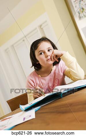 Grade school girl distracted from homework View Large Photo Image Stock Photograph - Grade school girl distracted from homework. Fotosearch