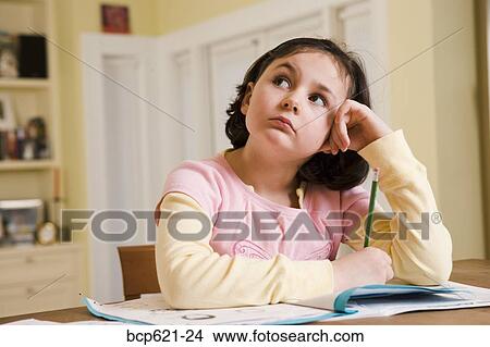 Grade school girl doing homework View Large Photo Image Picture - Grade school girl doing homework. Fotosearch