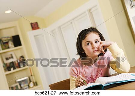 Grade school girl sulking over homework View Large Photo Image Stock Photo - Grade school girl sulking over homework. Fotosearch