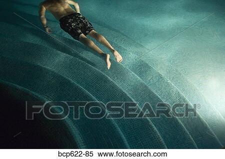 Stock Photography - Man floating underwater in pool. Fotosearch