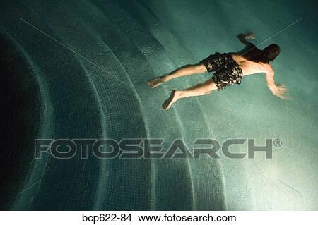 Man swimming underwater in pool View Large Photo Image Picture - Man swimming underwater in pool. Fotosearch