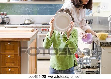 Mom and daughter unloading dishwasher View Large Photo Image Stock Photo - Mom and daughter unloading dishwasher. Fotosearch