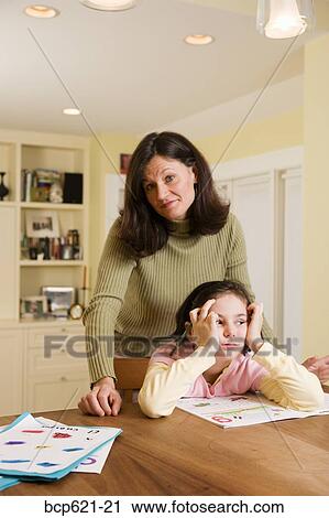 Mom with bored daughter doing homework View Large Photo Image Stock Image - Mom with bored daughter doing homework. Fotosearch
