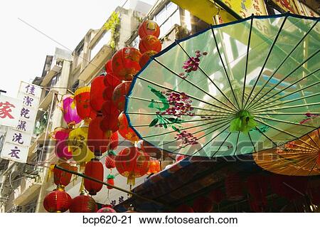 Parasols and lanterns hanging outside Hong Kong shop View Large Photo Image Stock Image - Parasols and lanterns hanging outside Hong Kong shop. Fotosearch