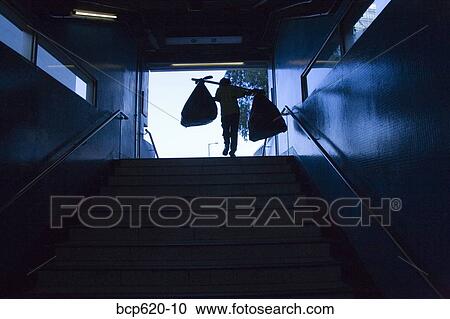 Person exiting subway with bags on shoulders View Large Photo Image Stock Image - Person exiting subway with bags on shoulders. Fotosearch