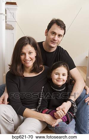 Portrait of couple holding hands with daughter View Large Photo Image Stock Image - Portrait of couple holding hands with daughter. Fotosearch