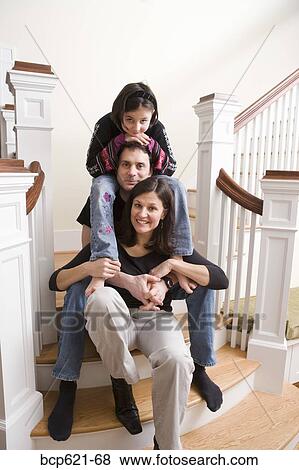 Portrait of couple with daughter on stairs View Large Photo Image Stock Photo - Portrait of couple with daughter on stairs. Fotosearch