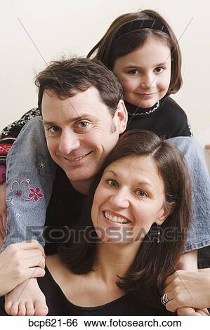 Stock Photograph - Portrait of parents and young daughter. Fotosearch