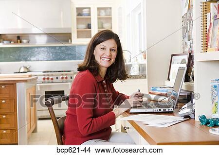 Portrait of woman using laptop computer View Large Photo Image Picture - Portrait of woman using laptop computer. Fotosearch