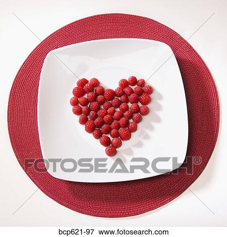 Raspberries arranged in heart shape View Large Photo Image Stock Photo - Raspberries arranged in heart shape. Fotosearch