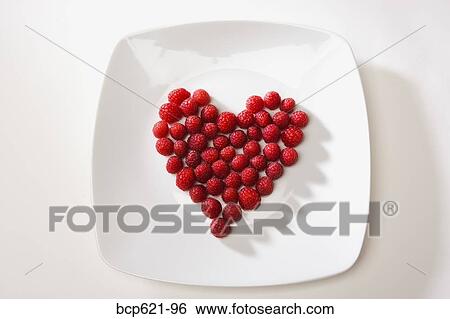 Raspberries arranged in heart shape View Large Photo Image Stock Photograph - Raspberries arranged in heart shape. Fotosearch