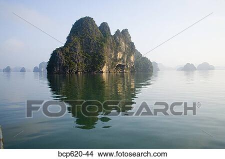 Rocky islands with still water in misty morning View Large Photo Image Picture - Rocky islands with still water in misty morning. Fotosearch