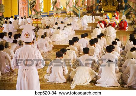 Picture - Rows of nuns and monks in Vietnamese temple. Fotosearch