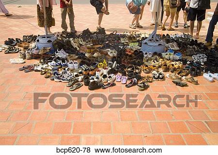 Stock Photo - Shoes on bricks outside Vietnamese temple. Fotosearch
