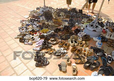 Stock Photo - Shoes on bricks outside Vietnamese temple. Fotosearch