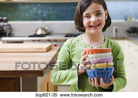 Smiling girl with stack of bowls View Large Photo Image Stock Photography - Smiling girl with stack of bowls. Fotosearch