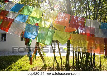 Sunshine through prayer flags at Buddhist monastery View Large Photo Image Picture - Sunshine through prayer flags at Buddhist monastery. Fotosearch