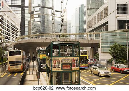 Stock Image - Tram stop on busy street in Hong Kong. Fotosearch