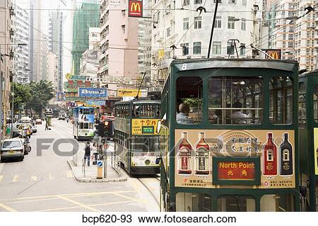 Stock Image - Trams and tall buildings in Hong Kong. Fotosearch