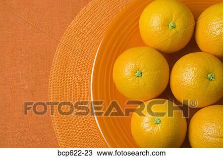 Whole oranges on an orange plate View Large Photo Image Stock Image - Whole oranges on an orange plate. Fotosearch