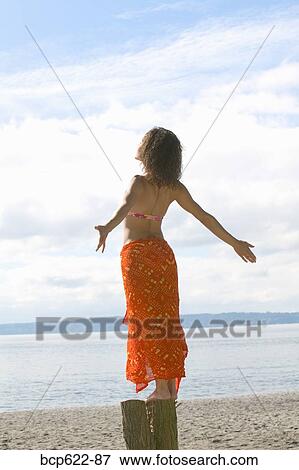 Woman basking in sun on beach View Large Photo Image Stock Photo - Woman basking in sun on beach. Fotosearch