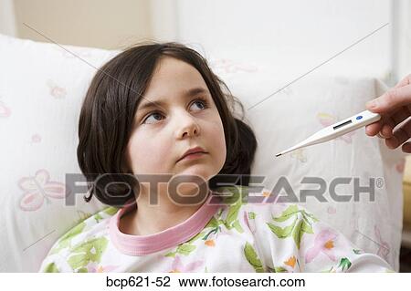 Young girl having temperature taken View Large Photo Image Stock Image - Young girl having temperature taken. Fotosearch