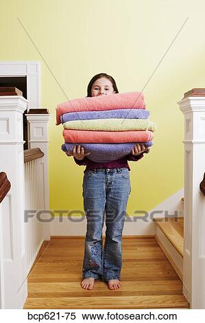 Young girl with stack of towels on stairs View Large Photo Image Stock Photography - Young girl with stack of towels on stairs. Fotosearch