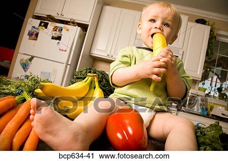 Stock Image - baby, banana, bell pepper, biting, boy, carrot. Fotosearch