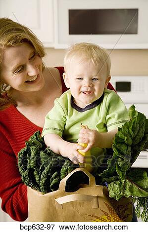 Stock Photo - baby, banana, boy, caring, caucasian, childhood. Fotosearch