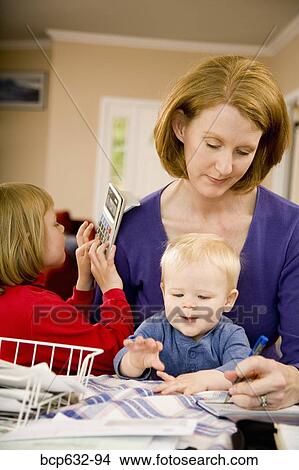 Picture - baby, boy, brother, calculator, caucasian, checkbook, childhood. Fotosearch