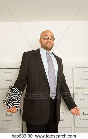 balding, file cabinet, eyeglasses, businessman, african ethnicity View Large Photo Image Stock Image - balding, file cabinet, eyeglasses, businessman, african ethnicity. Fotosearch