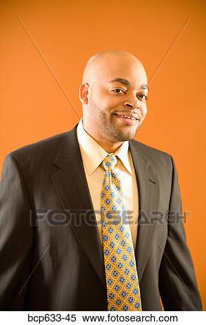 Stock Photography - balding, fortysomething, businessman, african ethnicity. Fotosearch