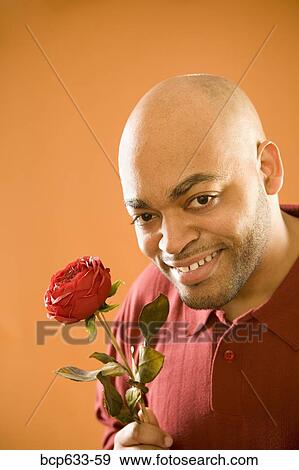 balding, fortysomething, flower, close up, african ethnicity View Large Photo Image Stock Photo - balding, fortysomething, flower, close up, african ethnicity. Fotosearch