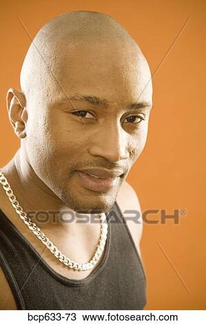 Stock Image - balding, head & shoulders, close up, chain, african ethnicity. Fotosearch