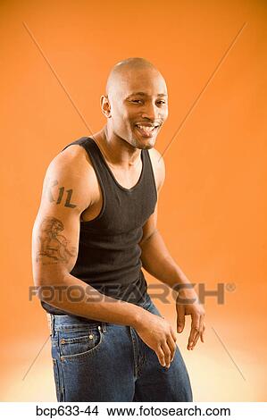Picture - balding, muscular, happy, african ethnicity. Fotosearch