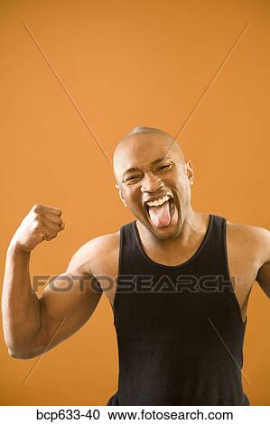 Stock Image - balding, muscular, happy, african ethnicity. Fotosearch