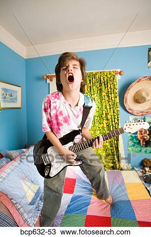 Stock Image - bedroom, childhood, caucasian, boy, adolescent. Fotosearch