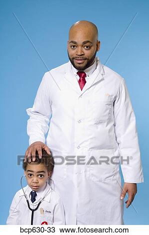 Stock Image - boy, doctor, childhood, caring, african ethnicity. Fotosearch