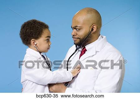 Stock Photography - boy, doctor, childhood, caring, african ethnicity. Fotosearch