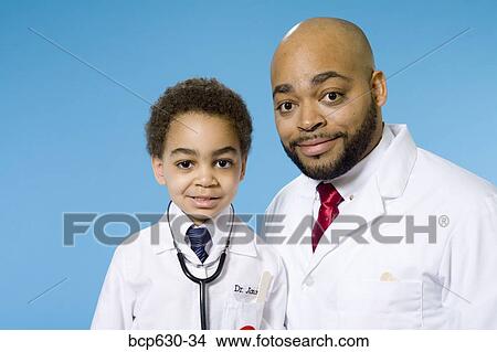 Picture - boy, elementary age, doctor, childhood, african ethnicity. Fotosearch