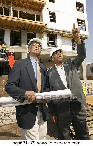 businessman, afternoon, business, blueprint, background people, african ethnicity View Large Photo Image Stock Photo - businessman, afternoon, business, blueprint, background people, african ethnicity. Fotosearch