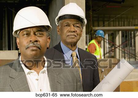 Stock Photography - businessman, afternoon, business, blueprint, background people, african ethnicity. Fotosearch