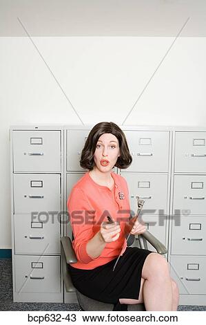 Stock Image - businesswoman, file cabinet, clipboard, caucasian, administrator. Fotosearch