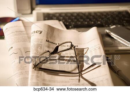 cd rom, cell phone, eyeglasses, finance, high angle View Large Photo Image Picture - cd rom, cell phone, eyeglasses, finance, high angle. Fotosearch