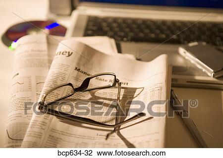 Stock Image - cd rom, cell phone, eyeglasses, finance, high angle. Fotosearch