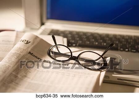 Stock Photography - eyeglasses, finance, high angle, inside, laptop. Fotosearch
