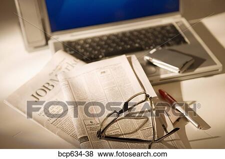 Stock Photo - high angle, cell phone, finance, eyeglasses, circle, advertisement. Fotosearch