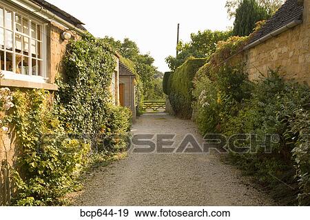 Alley between stone cottages, Gloucestershire, United Kingdom View Large Photo Image Stock Photo - Alley between stone cottages, Gloucestershire, United Kingdom. Fotosearch